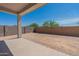 Large backyard features a covered patio and block wall fence at 18047 W Long Lake Rd, Goodyear, AZ 85338