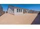 Backyard featuring block wall fencing, rear covered patio, and neutral earth tones at 18047 W Long Lake Rd, Goodyear, AZ 85338