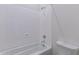 This clean, white bathroom has a bathtub with shower and white ceramic toilet at 18047 W Long Lake Rd, Goodyear, AZ 85338