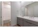 This bathroom features a double sink vanity with a large mirror and bathtub with shower at 18047 W Long Lake Rd, Goodyear, AZ 85338