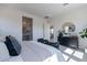 Sunlit bedroom featuring neutral decor, plush carpeting, and designer furnishings at 18047 W Long Lake Rd, Goodyear, AZ 85338