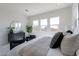 Bright primary bedroom featuring plush carpeting and multiple windows for natural light at 18047 W Long Lake Rd, Goodyear, AZ 85338
