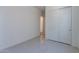 This is a bright bedroom with double closets and a doorway leading to another room at 18047 W Long Lake Rd, Goodyear, AZ 85338