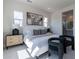 Sunlit bedroom featuring neutral decor, plush carpeting, and picturesque windows at 18047 W Long Lake Rd, Goodyear, AZ 85338
