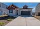 Charming single-Gathering home featuring a two-car garage, contrasting trim, and low maintenance desert landscaping at 18047 W Long Lake Rd, Goodyear, AZ 85338