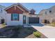 Charming single-Gathering home featuring a two-car garage, contrasting trim, and low maintenance desert landscaping at 18047 W Long Lake Rd, Goodyear, AZ 85338