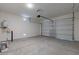 Spacious two car garage with concrete floor, garage door opener, and water heater at 18047 W Long Lake Rd, Goodyear, AZ 85338
