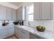 Bright kitchen featuring marble countertops, subway tile backsplash, and stainless steel appliances at 18047 W Long Lake Rd, Goodyear, AZ 85338