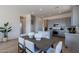 Bright eat-in kitchen features grey cabinets, granite countertops, and stainless steel appliances at 18047 W Long Lake Rd, Goodyear, AZ 85338