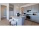 Kitchen island with marble countertop, bar stools, and modern appliances and fixtures at 18047 W Long Lake Rd, Goodyear, AZ 85338