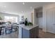 Open-concept living space featuring a kitchen island, dining area, and living room at 18047 W Long Lake Rd, Goodyear, AZ 85338