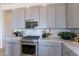 Charming kitchen with stainless steel appliances, marble counters, and ample cabinet space at 18047 W Long Lake Rd, Goodyear, AZ 85338