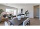 Open-concept living and dining area with sliding glass doors to the outdoor space at 18047 W Long Lake Rd, Goodyear, AZ 85338