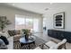 Stylish living room featuring modern furniture, neutral tones, and a sliding glass door to the outdoor space at 18047 W Long Lake Rd, Goodyear, AZ 85338