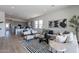 Open-concept living room seamlessly connecting to the kitchen, with stylish furniture and plenty of natural light at 18047 W Long Lake Rd, Goodyear, AZ 85338
