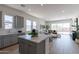 Bright, open-concept space with a modern kitchen island and view into the living area at 18047 W Long Lake Rd, Goodyear, AZ 85338
