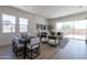 Inviting open-concept living space with dining area and large windows at 18047 W Long Lake Rd, Goodyear, AZ 85338