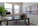 This modern office space has lots of natural light, modern artwork, and a stylish desk at 18047 W Long Lake Rd, Goodyear, AZ 85338