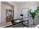 Well-lit home office showcasing a sleek desk, decorative elements, and neutral tones creating a calm workspace at 18047 W Long Lake Rd, Goodyear, AZ 85338