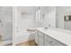 Bright white bathroom with a bathtub and shower, sink and vanity, and tiled floors at 18203 W Port Royale Ln, Surprise, AZ 85388