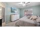Comfortable bedroom features a TV, ceiling fan, with carpet and white trim throughout at 18203 W Port Royale Ln, Surprise, AZ 85388