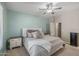 Bright bedroom features a ceiling fan, with carpet and white trim throughout at 18203 W Port Royale Ln, Surprise, AZ 85388