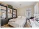 Cozy bedroom featuring custom built-ins, soft carpet, and a vanity with Hollywood-style lighting at 18203 W Port Royale Ln, Surprise, AZ 85388