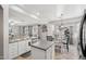 Bright kitchen with granite countertops, stainless steel appliances, and adjacent dining area with a sliding glass door at 18203 W Port Royale Ln, Surprise, AZ 85388
