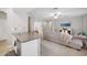 Open concept kitchen with stainless steel appliances and an island, seamlessly flowing into the living room at 18203 W Port Royale Ln, Surprise, AZ 85388