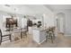 Well-lit kitchen featuring white cabinets, stainless appliances, and an island with bar seating at 18203 W Port Royale Ln, Surprise, AZ 85388