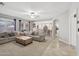 Open concept living room with neutral tones, ample seating, and lots of natural light at 18203 W Port Royale Ln, Surprise, AZ 85388