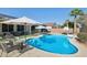 Outdoor oasis featuring a beautiful pool, covered patio, and lounge chairs, perfect for relaxing at 18203 W Port Royale Ln, Surprise, AZ 85388