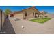 Backyard featuring desert landscaping, a picnic table, and a view of the home's exterior at 18241 W Foothill Dr, Surprise, AZ 85387