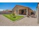 Landscaped backyard with a small lawn, patio furniture, and views of the rear of the home at 18241 W Foothill Dr, Surprise, AZ 85387