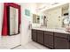 Bathroom featuring double sink vanity and decorative mirrors at 18241 W Foothill Dr, Surprise, AZ 85387
