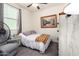 Bright bedroom with a queen bed, neutral tones, and a serene painting on the wall at 18241 W Foothill Dr, Surprise, AZ 85387