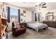 Bedroom showcasing a leather chair and light from two windows at 18241 W Foothill Dr, Surprise, AZ 85387
