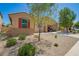 Charming single-story home boasts a well-maintained desert landscape and convenient drive-through garage at 18241 W Foothill Dr, Surprise, AZ 85387