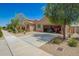 Charming single-story home boasts a well-maintained desert landscape and convenient drive-through garage at 18241 W Foothill Dr, Surprise, AZ 85387