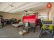 Spacious garage with ample storage, featuring a red trailer and utility equipment at 18241 W Foothill Dr, Surprise, AZ 85387