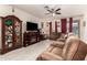 Spacious living room featuring tile floors, ceiling fan, and comfortable reclining sofa at 18241 W Foothill Dr, Surprise, AZ 85387