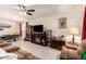 Open-concept living room with tile floors and view to dining area at 18241 W Foothill Dr, Surprise, AZ 85387