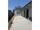 A concrete patio at the back of the home is bordered by siding and block fencing at 2045 E Orange St, Tempe, AZ 85281