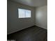 Bedroom featuring neutral paint, laminate flooring, and a window at 2045 E Orange St, Tempe, AZ 85281