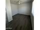 A simple bedroom has dark wood-look floors and neutral-painted walls and trim at 2045 E Orange St, Tempe, AZ 85281