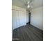Bedroom with bi-fold closet, window and dark wood-look flooring at 2045 E Orange St, Tempe, AZ 85281