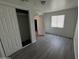 Bedroom featuring wood-look floors, sliding closet doors and a window at 2045 E Orange St, Tempe, AZ 85281