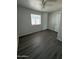 This bedroom is bright, features a ceiling fan, and dark wood-look floors at 2045 E Orange St, Tempe, AZ 85281