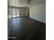 Open living space featuring sleek laminate flooring, and a glass sliding door to the back patio at 2045 E Orange St, Tempe, AZ 85281