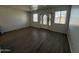 Bright living room featuring wood flooring, a ceiling fan, and plenty of natural light from the windows at 2045 E Orange St, Tempe, AZ 85281